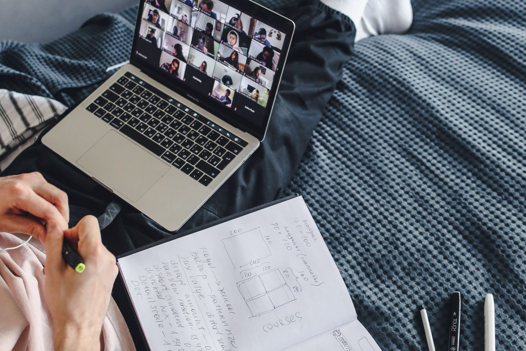 Home Person engaging in a video call while studying on a laptop at home.